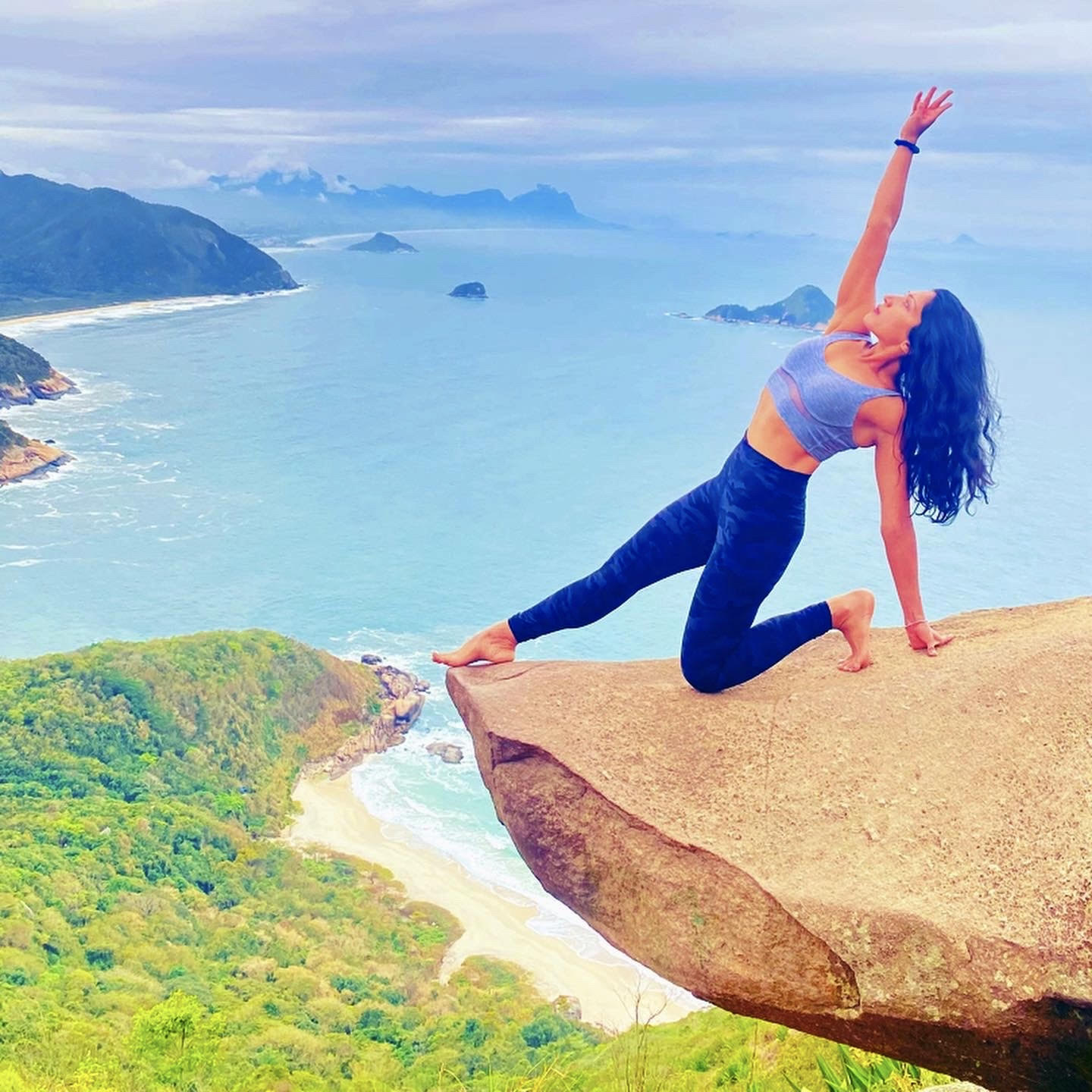 Swati in a yoga pose on a rock
